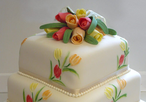 A 3-tier Wedding Cake with flowers 